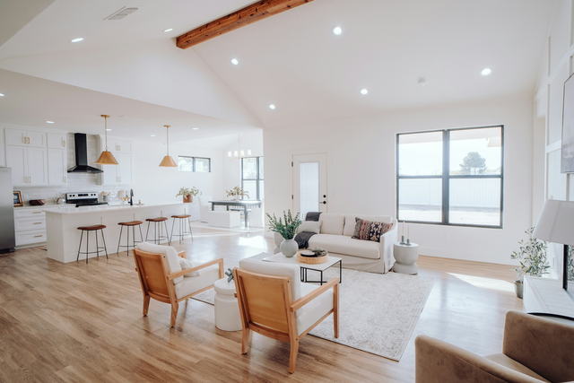 An open plan kitchen and living room under a vaulted ceiling, cleaned and ready for a viewing